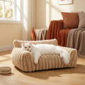 The Corduroy Lounger pet sofa in golden-hour light with a lounging cat — Loaf & Whisker