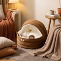 The Velvet Den plush cat nest in a cozy lamplit bedroom corner with a sleeping cat — Loaf & Whisker