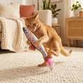 The Trout Kicker being bunny-kicked on a cozy cream rug — Loaf & Whisker